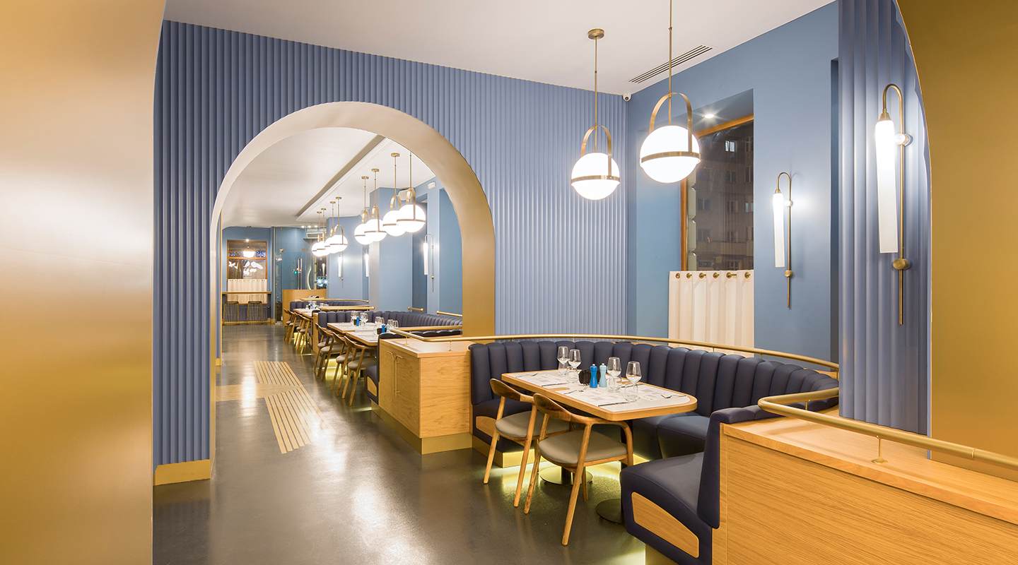 Amenajare interioara in culorile albastru si galben a restaurantului 1896 Brasserie & Lounge